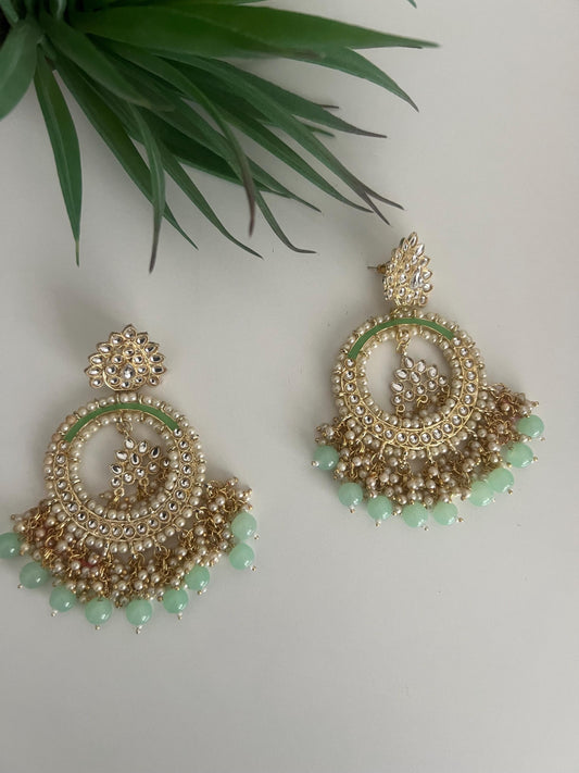 big dangling chandbaali light green and faux pearl earrings.