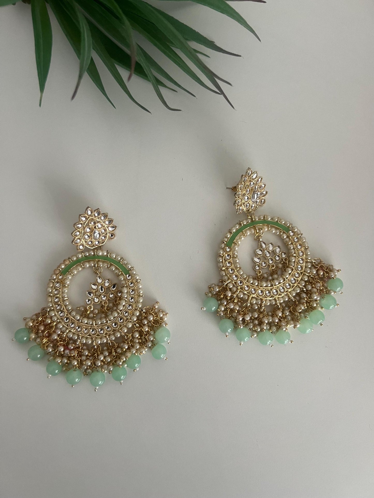 big dangling chandbaali light green and faux pearl earrings.